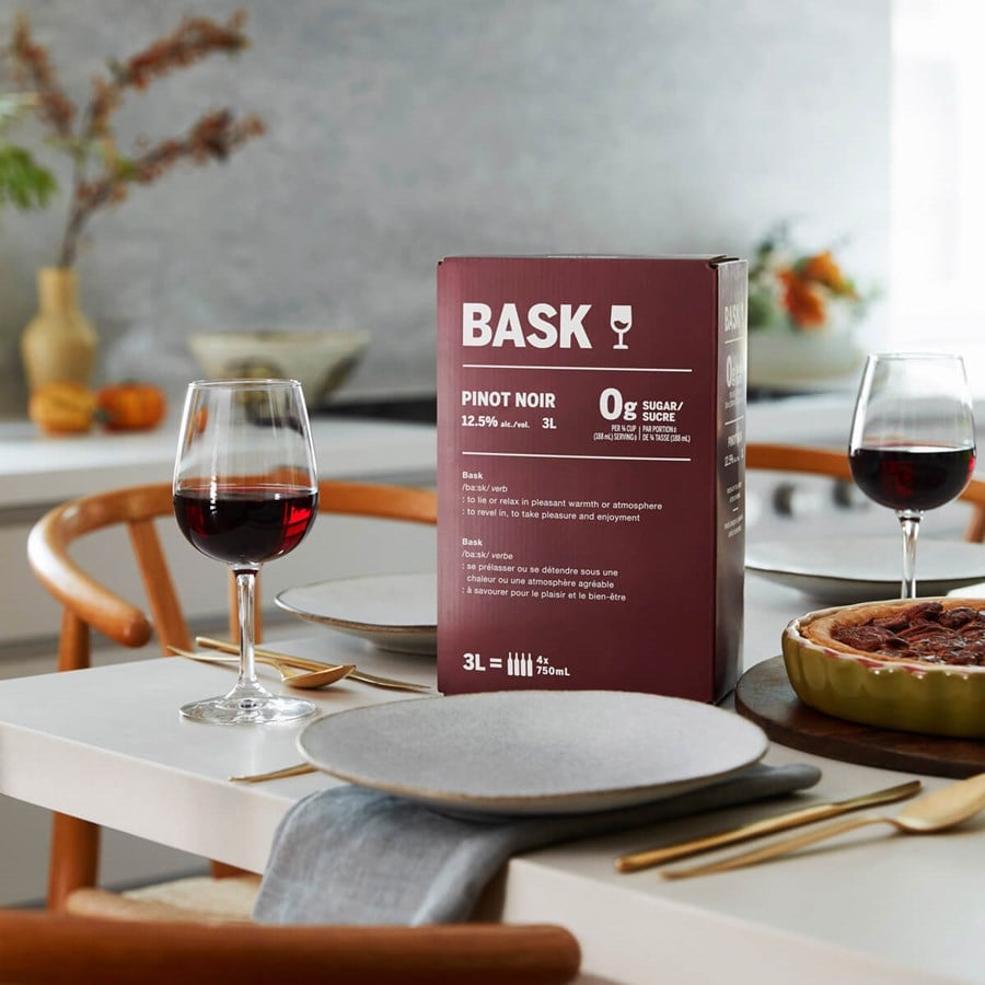 Pinot Noir 3L box with a glass of wine on a table